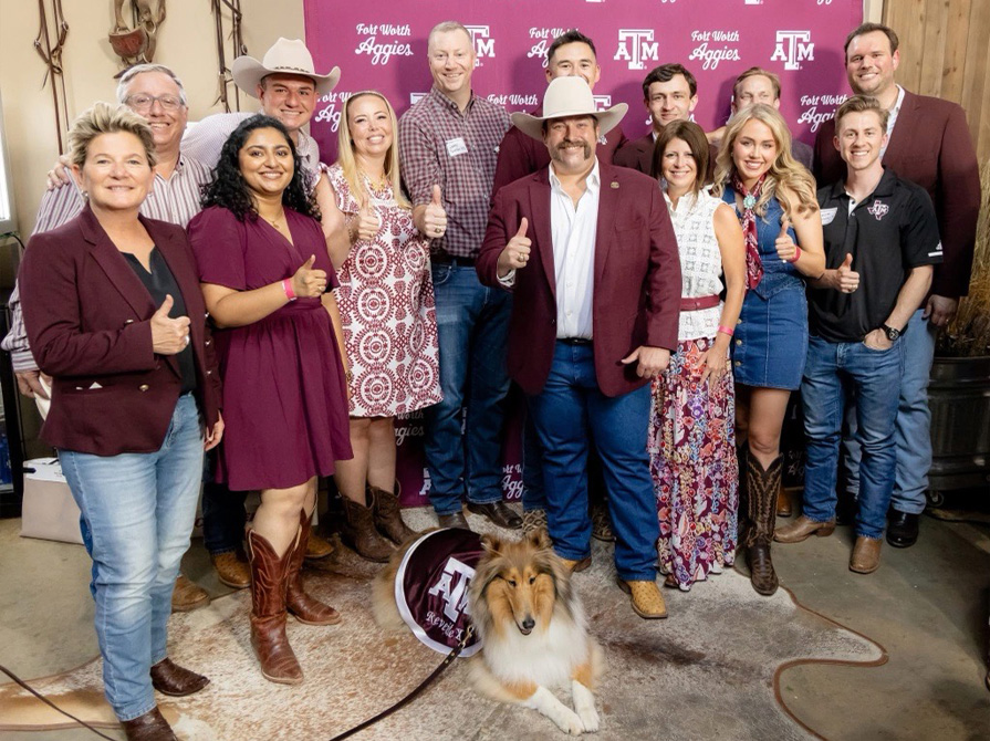International A&M Club holding a Texas A&M flag