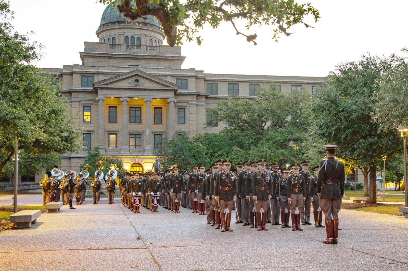 Photo of the cadets standing in formation in front of a university building