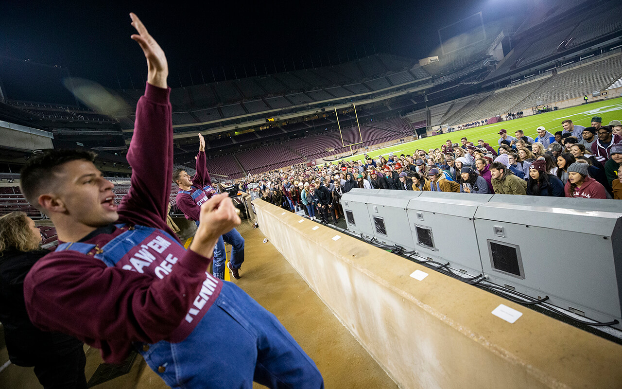 Color photo of Texas A&M yell leaders and seniors gathered in Kyle Field during Elephant Walk.