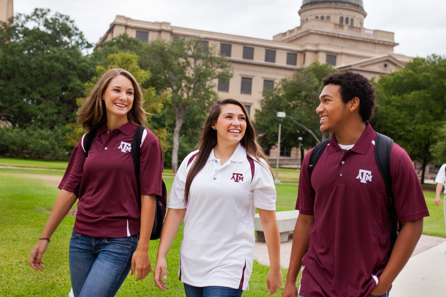 Three Texas A&M Students walking in front of the Academic Building